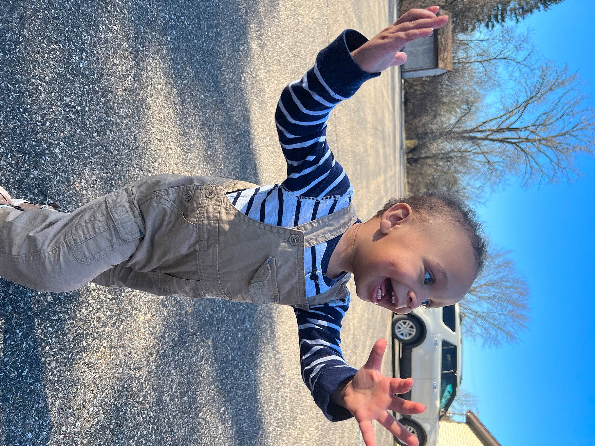 Asiah is registered to the contest to win money with this photo: azure, child, cool, daytime, fun, gesture, hand, happy, human, leisure, line, people_in_nature, person, photograph, plant, sky, smile, standing, toddler, tree