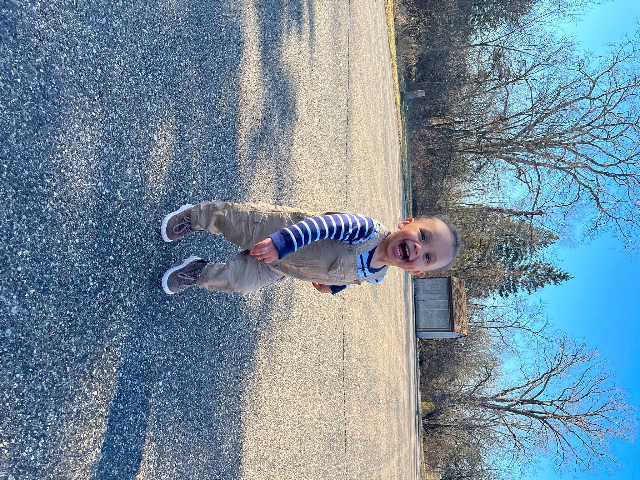 Asiah is registered to the contest to win money with this photo: azure, blue, denim, electric_blue, fun, grass, happy, leisure, people_in_nature, person, plant, recreation, reflection, shadow, sky, soil, tints_and_shades, toddler, tree, water