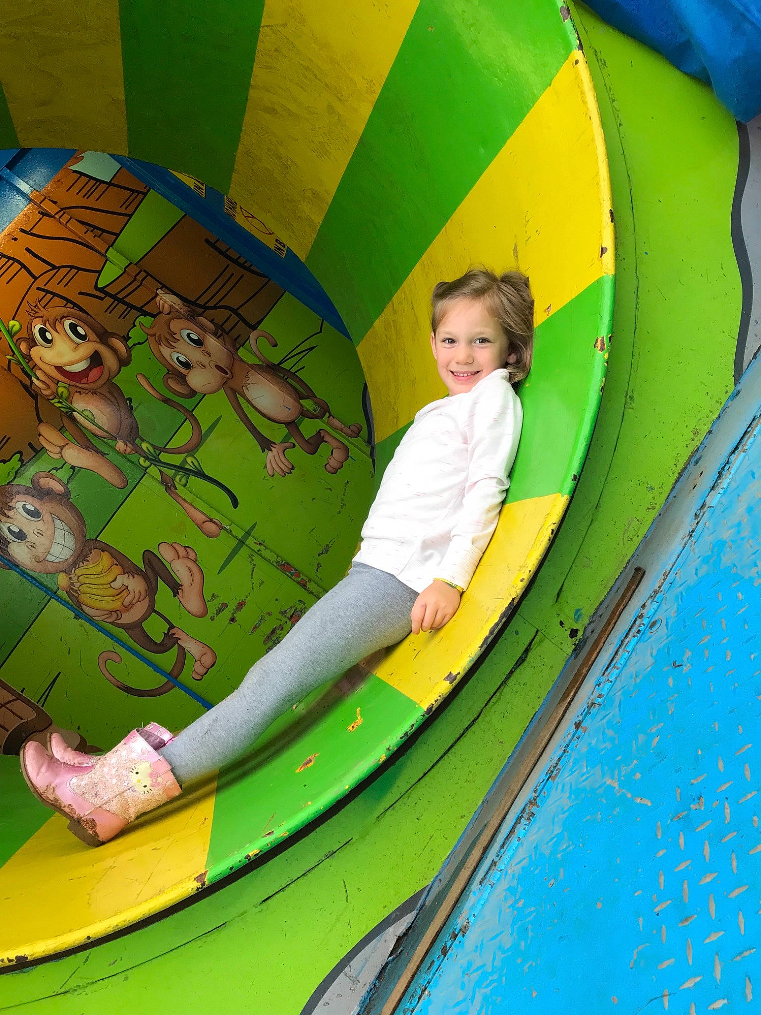 Adelaide is registered to the contest to win money with this photo: amusement_park, child, circle, fun, games, green, inflatable, joy, leisure, outdoor_play_equipment, person, play, playground_slide, recreation, water_park, world, yellow