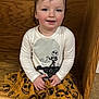 Navaya is registered to the contest to win money with this photo: brown_shoes, carpet, child, costume, cute, earrings, face, fall_theme, happy, holiday_clothing, indoors, long_sleeve_shirt, pants, person, pumpkin_pattern, sitting, skirt, smiling, toddler, wooden_background