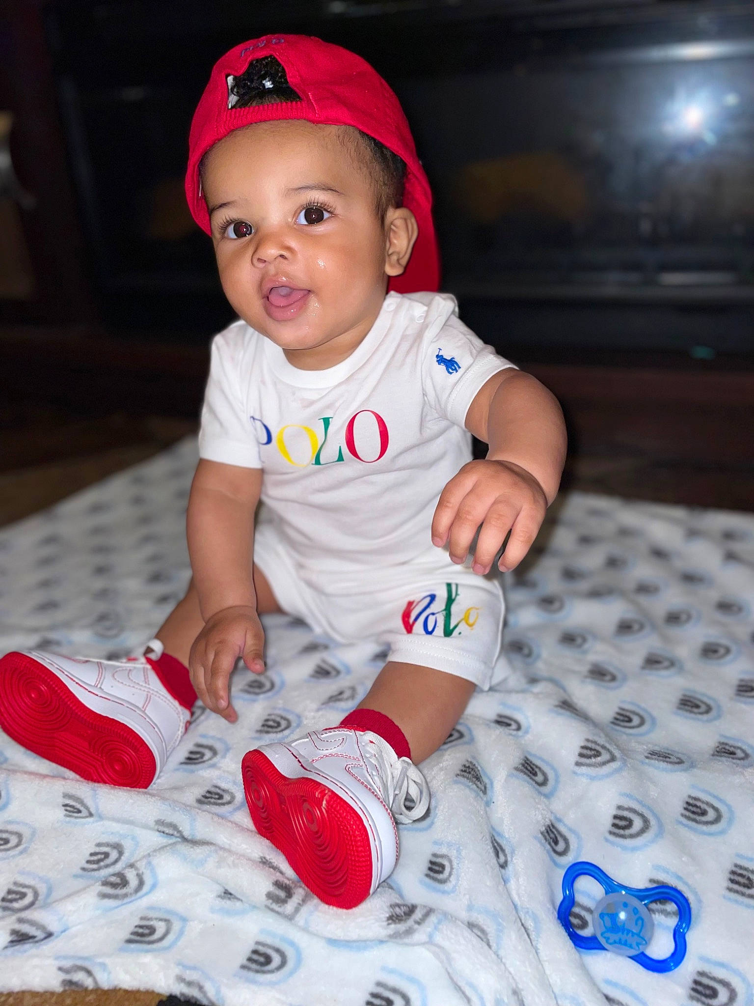 Jamie joined the competition — help win amazing prizes! baby, baby_toddler_clothing, baseball_cap, cap, carmine, cheek, child, electric_blue, flooring, fun, happy, hat, pattern, person, pink, red, sitting, sleeve, smile, t_shirt