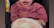 Freyja is registered to the contest to win money with this photo: baby, baby_girl, blanket, blanket_pattern, car_seat, child, clothing, cozy, cute, face, happy, head, indoors, infant, person, pink_bow, pink_sweater, portrait, sitting, smile