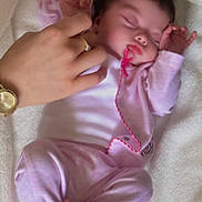 Freyja is registered to the contest to win money with this photo: baby, sleeping, infant, pink_clothing, blanket, hands, soft, cozy, peaceful, newborn, cute, relaxing, indoor, portrait, child, toddler, face, foot, person, resting