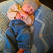 Atlas joined the competition — help win amazing prizes! baby, sleeping, hat, sweater, jeans, crocheted_blanket, cozy, indoor, soft_texture, peaceful, child, foot, hand, nap, warm_clothing, couch, home, portrait, infant, relaxation