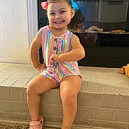Alexa joined the competition — help win amazing prizes! toddler, child, smiling, colorful_clothing, romper, pink_shoes, hair_bows, indoor, fireplace, brick_hearth, reflection, happy, cute, posing, person, young_child, footwear, playful, casual, family