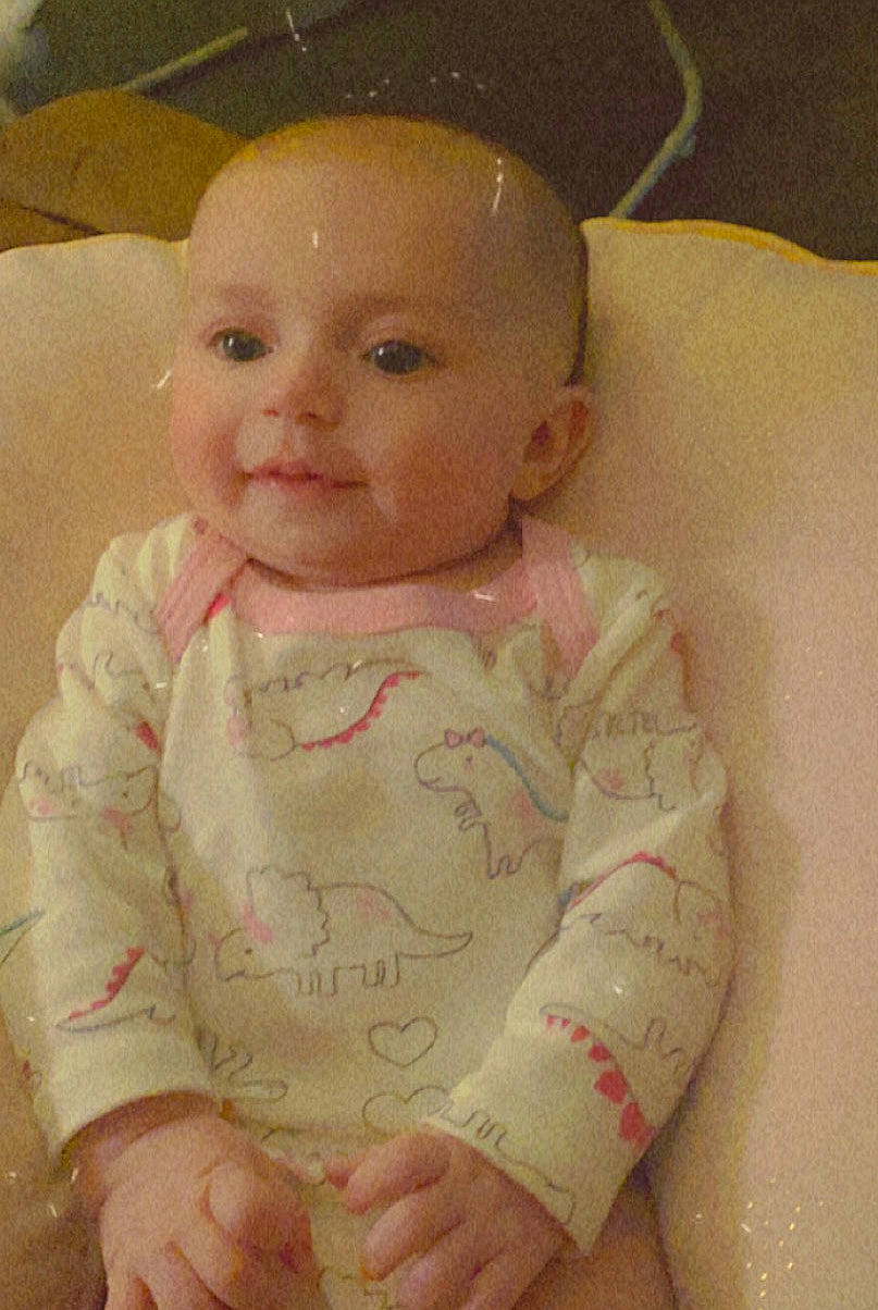 Nola is registered to the contest to win money with this photo: baby, cheek, child, chin, ear, eye, face, finger, forehead, hand, head, iris, lip, nose, person, pink, skin, smile, toddler