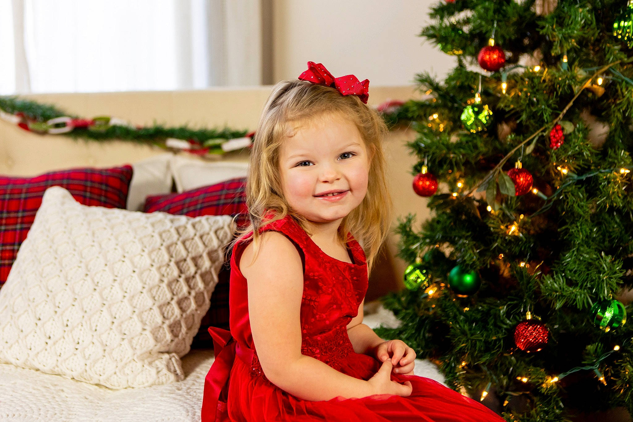 Emma joined the competition — help win amazing prizes! child, christmas, christmas_decoration, christmas_eve, christmas_ornament, christmas_tree, conifer, event, evergreen, grass, happy, holiday, interior_design, joy, person, plant, red, sitting, smile, toddler