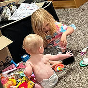 Marlin joined the competition — help win amazing prizes! child, baby, playing, toys, carpet, diaper, blonde_hair, indoor, sitting, book, shelf, colorful_clothing, curious, floor, home, young_child, toddler, casual, family, interaction