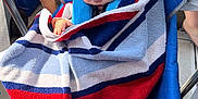 Walker is registered to the contest to win money with this photo: baby, child, sleeping, towel, striped_towel, blue_chair, person, legs, outdoor, shade, hand, comfort, nap, rest, infant, seat, fabric, casual, relaxation, summer