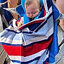 baby, child, sleeping, towel, striped_towel, blue_chair, person, legs, outdoor, shade, hand, comfort, nap, rest, infant, seat, fabric, casual, relaxation, summer
