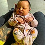 baby, newborn, infant, sleeping, pajamas, floral, hand, tattoo, arm, person, clothing, legs, footwear, indoor, floor, relaxing, cute, small, peaceful, holding