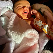 Aniyah joined the competition — help win amazing prizes! baby, newborn, blanket, sleeping, infant, soft, cozy, hand, face, skin, wrapped, cute, warm_light, resting, indoors, comfort, peaceful, young_child, portrait, fabric