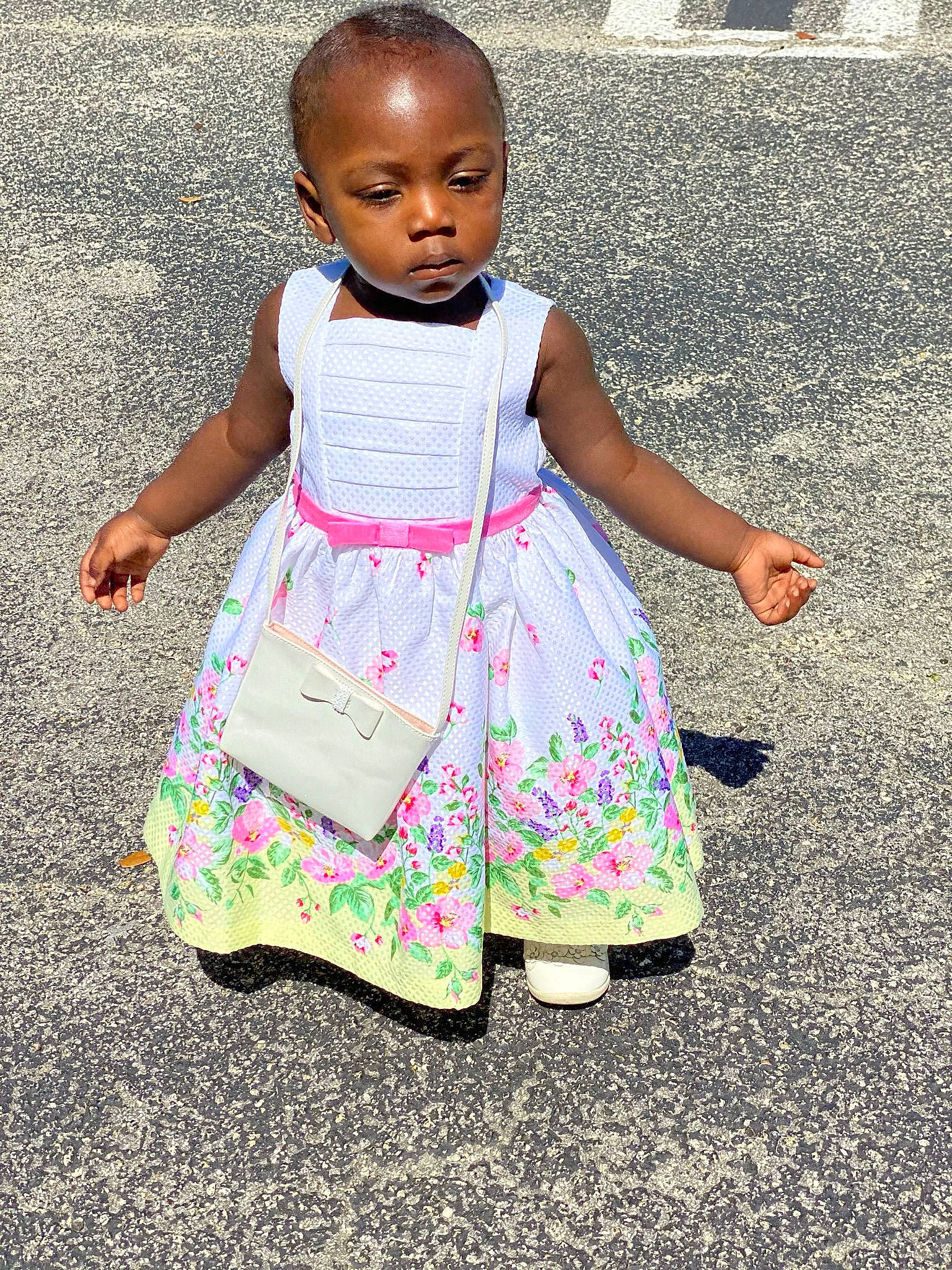 Whitley Tilme is registered to the contest to win money with this photo: arm, baby_toddler_clothing, child, day_dress, dress, grass, hairstyle, hand, happy, head, human_body, human_leg, one_piece_garment, pattern, people, people_in_nature, person, pink, sleeve, t_shirt