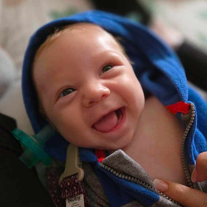 Oliver is registered to the contest to win money with this photo: baby, babylaughing, bonnet, clothing, coat, face, happy, hat, head, hood, hoodie, jacket, knitwear, laughing, person, photography, portrait, smile, sweater, sweatshirt