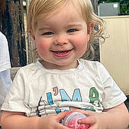 Mason joined the competition — help win amazing prizes! toddler, child, smiling, outdoor, bench, blonde_hair, rosy_cheeks, white_tshirt, colorful_letters, holding_object, plastic_container, happy, portrait, daylight, casual_clothing, wooden_bench, nature_background, cute, playful, person