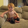toddler, child, baby, sitting, couch, sofa, headphones, audio_equipment, indoor, portrait, face, red_hair, smiling, bare_chested, barefoot, living_room, furniture, curtains, home, photography