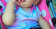 Raighlynn is registered to the contest to win money with this photo: toddler, child, smiling, stroller, polka_dot, pink, curly_hair, blue_pants, outdoor, grass, casual_clothing, happy, baby, seatbelt, hand, face, portrait, daylight, playful, cute