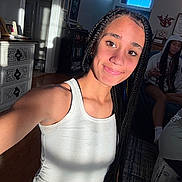 Raighlynn joined the competition — help win amazing prizes! girl, braids, selfie, white_tank_top, smile, indoor, sunlight, shadow, furniture, dresser, people, casual, relaxing, room, young_person, portrait, happy, home, candid, friends