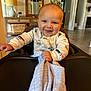 baby, blanket, child, clothing, cozy, decor, face, furniture, happy, high_chair, home, indoor, lamp, mirror, person, plant, portrait, smiling, table, wood_floor
