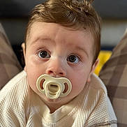 Cooper joined the competition — help win amazing prizes! baby, child, close_up, cozy, curly_hair, cute, expression, eyes, face, head, indoor, innocence, looking_up, pacifier, person, portrait, skin, soft_lighting, sweater, young_child