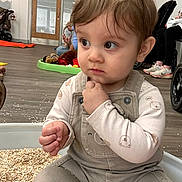 Cooper is registered to the contest to win money with this photo: adult, background, casual, child, clothing, curious, expression, face, floor, hair, hand, indoor, oats, overalls, person, playroom, sitting, toddler, toy, wheelchair