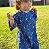 Cooper is registered to the contest to win money with this photo: background, blue_clothing, casual, child, curly_hair, cute, daylight, expression, fox_pattern, grass, greenery, nature, outdoor, patterned_clothing, playful, portrait, standing, sunlight, toddler, young_child
