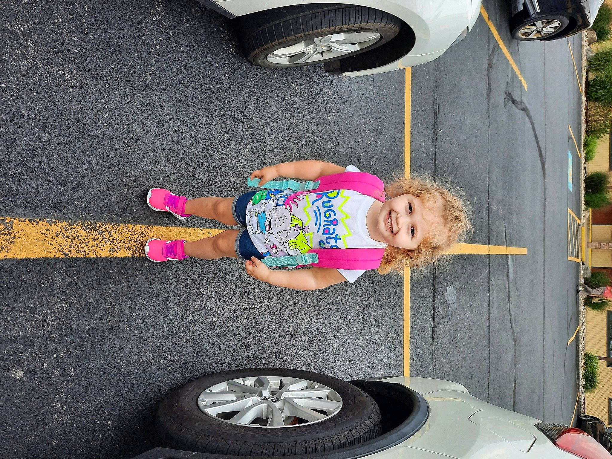 Lucille joined the competition — help win amazing prizes! asphalt, auto_part, automotive_exterior, automotive_tire, automotive_wheel_system, car, fender, hood, hubcap, joy, mode_of_transport, motor_vehicle, person, pink, shorts, smile, tire, toddler, vehicle, vehicle_door