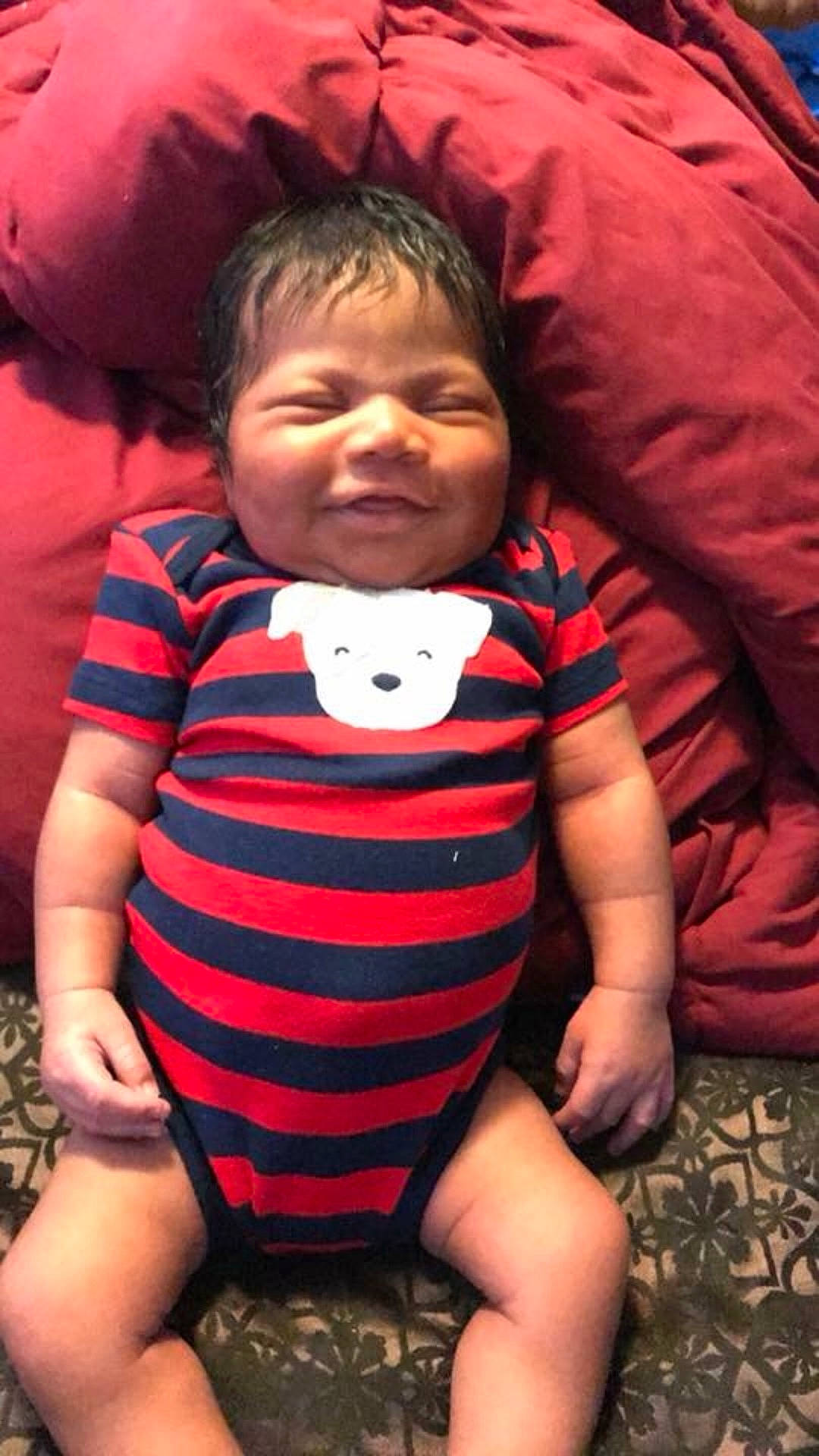 Na?siyah is registered to the contest to win money with this photo: arm, black_hair, cheek, child, cool, eye, face, facial_expression, head, human, infant, mouth, organ, person, pink, product, red, sitting, skin, smile