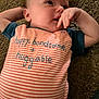 Salvateo is registered to the contest to win money with this photo: baby, infant, child, carpet, striped_clothing, hand, face, cute, lying_down, blue_shirt, expression, closeup, person, young_child, skin, cheek, small_fingers, casual, indoors, soft_lighting
