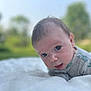 Salvateo is registered to the contest to win money with this photo: baby, infant, face, outdoor, blanket, soft_texture, curious, closeup, portrait, nature, greenery, child, young, expression, clothing, head, laying, skin, daylight, cute