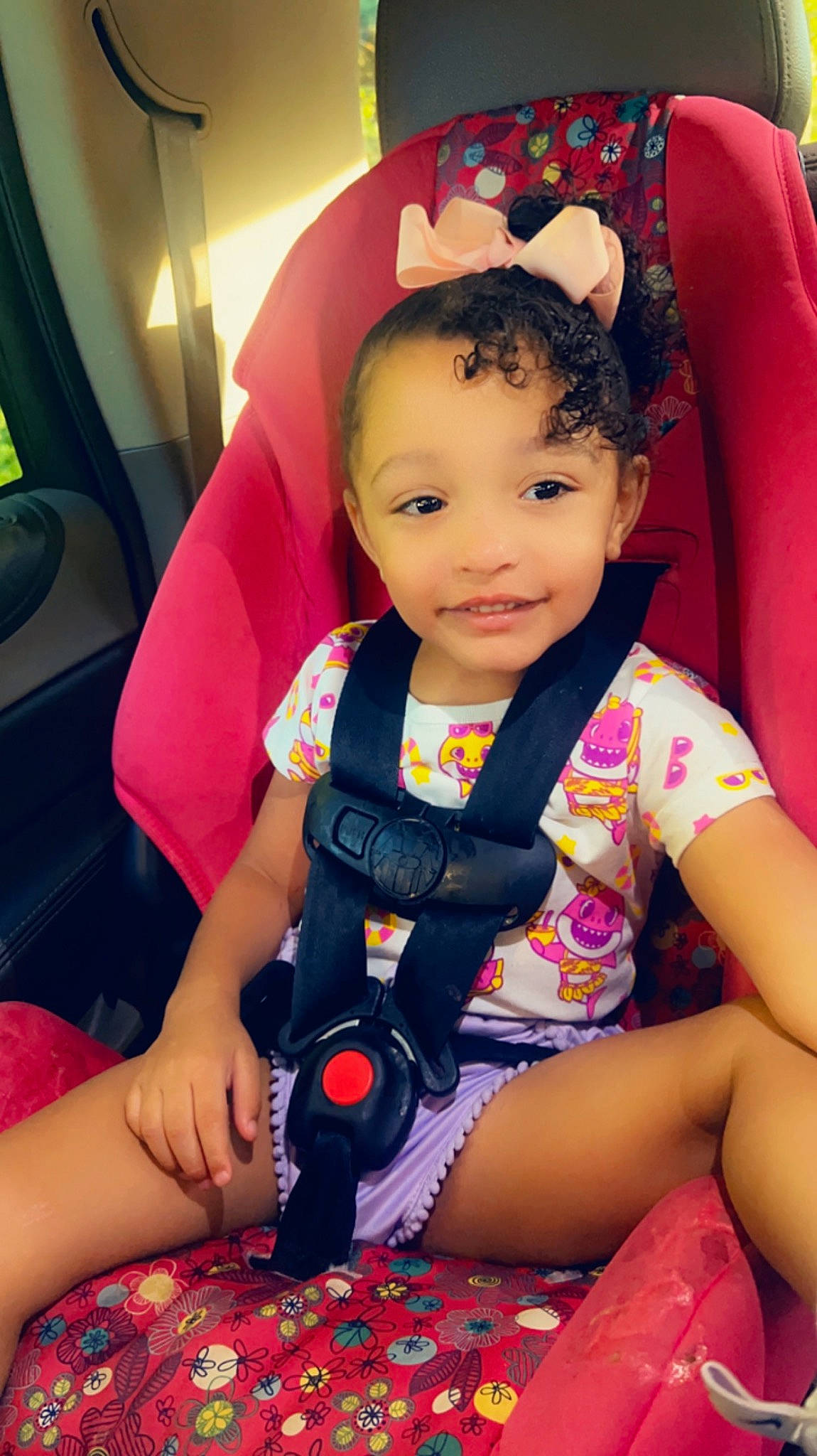 Jaylah is registered to the contest to win money with this photo: baby, baby_carriage, baby_products, baby_toddler_clothing, car_seat, carmine, child, comfort, fun, happy, joy, lap, leisure, magenta, nail, person, sitting, skin, smile, steering_wheel