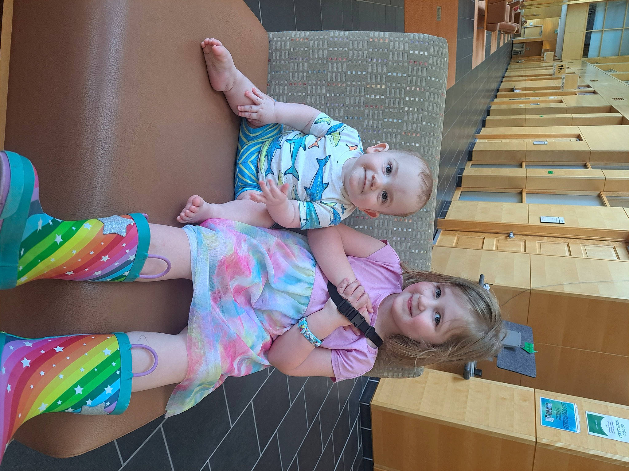 Finlay is registered to the contest to win money with this photo: baby_toddler_clothing, carton, child, comfort, fun, happy, human_leg, joy, knee, leisure, pattern, person, sandal, shipping_box, shorts, sitting, smile, sock, thigh, toddler