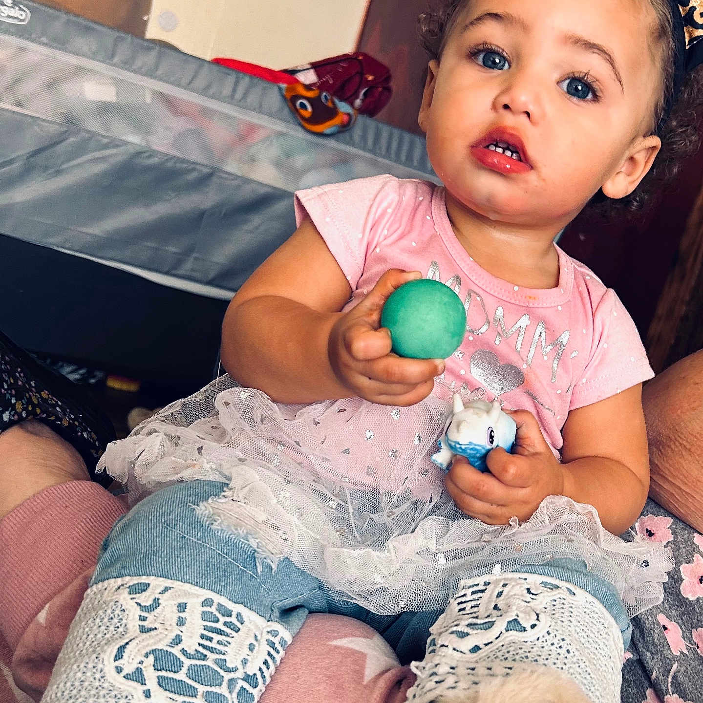 Gracie is registered to the contest to win money with this photo: baby, bodypart, clothing, couch, cushion, eating, face, finger, food, furniture, hand, head, pants, person, photography, portrait, sitting, sleeve, sweets, t_shirt