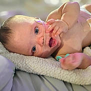 Raya joined the competition — help win amazing prizes! baby, infant, blanket, oxygen_tube, hospital, medical_tape, lying_down, blue_eyes, soft_texture, skin, newborn, cute, small_hands, face, expression, bed, resting, indoors, person, healthcare