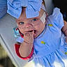 baby, child, blue_eyes, bow, headband, dress, striped, oxygen_tube, medical, infant, cute, hand, face, lying_down, indoors, soft_focus, skin, cheek_patch, adorable, person