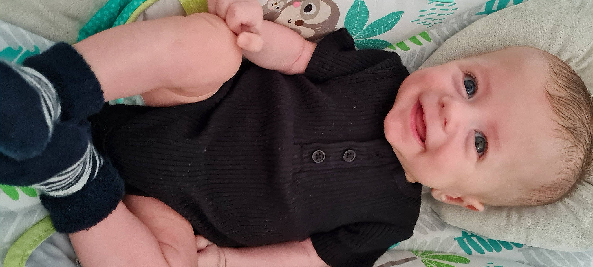 Dylan is registered to the contest to win money with this photo: baby, baby_toddler_clothing, cheek, child, eye, eyelash, fashion_accessory, finger, gesture, grass, hand, happy, joy, nail, pattern, person, skin, sleeve, smile, thumb