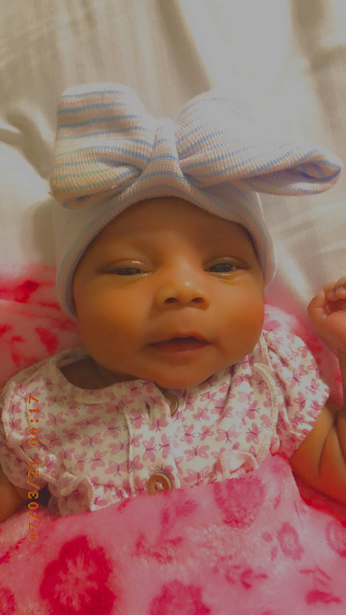 Avani is registered to the contest to win money with this photo: baby, baby_toddler_clothing, cheek, chin, eyebrow, eyelash, face, facial_expression, finger, happy, headwear, iris, lip, mouth, nose, person, pink, product, skin, sleeve