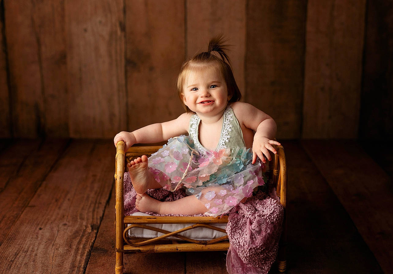 River Faye is registered to the contest to win money with this photo: baby, baby_toddler_clothing, chair, child, comfort, event, flash_photography, flooring, fun, happy, hardwood, joy, leisure, magenta, person, purple, room, sitting, skin, smile