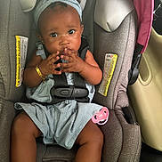 Kai'Loni is registered to the contest to win money with this photo: baby, car_seat, child, infant, safety_harness, pacifier, headband, dress, seat_belt, curious, indoors, child_seat, stripes, bracelet, cute, young_child, sitting, car_interior, secure, hands