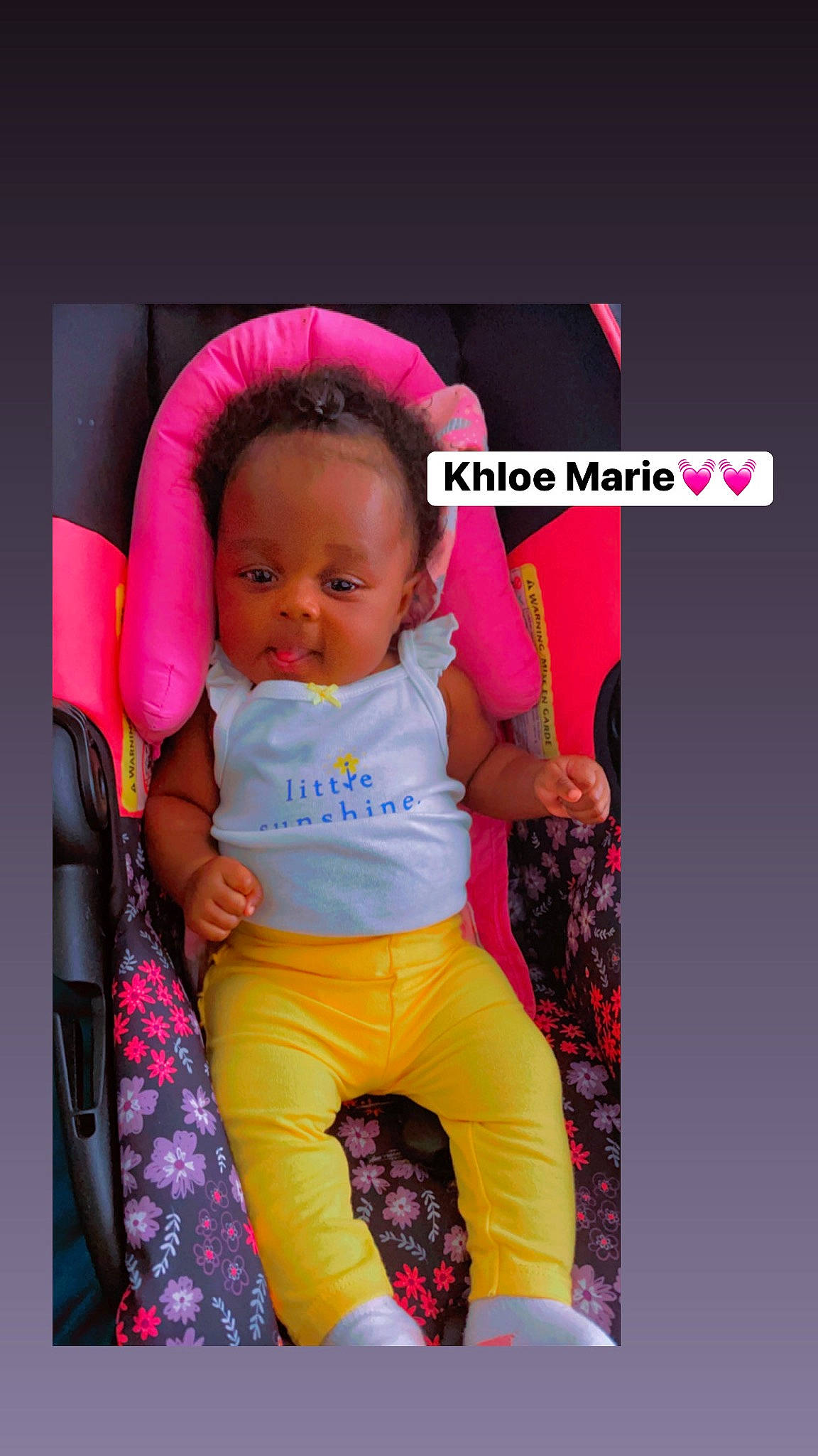 Khloe is registered to the contest to win money with this photo: arm, baby, baby_carriage, baby_products, baby_safety, baby_toddler_clothing, cheek, child, comfort, eye, fashion_accessory, fun, happy, head, magenta, person, pink, purple, sitting, sleeve