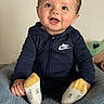 Charles participe au concours pour gagner de l'argent avec cette photo : baby, child, smiling, sitting, hoodie, nike, socks, blue, yellow, cute, happy, indoor, cushion, soft, portrait, clothing, person, infant, face, young