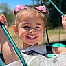 child, smiling, swing, outdoor, daylight, happy, girl, rope, playground, dress, hair_accessories, face, portrait, nature, sunlight, fun, leisure, closeup, childhood, joy