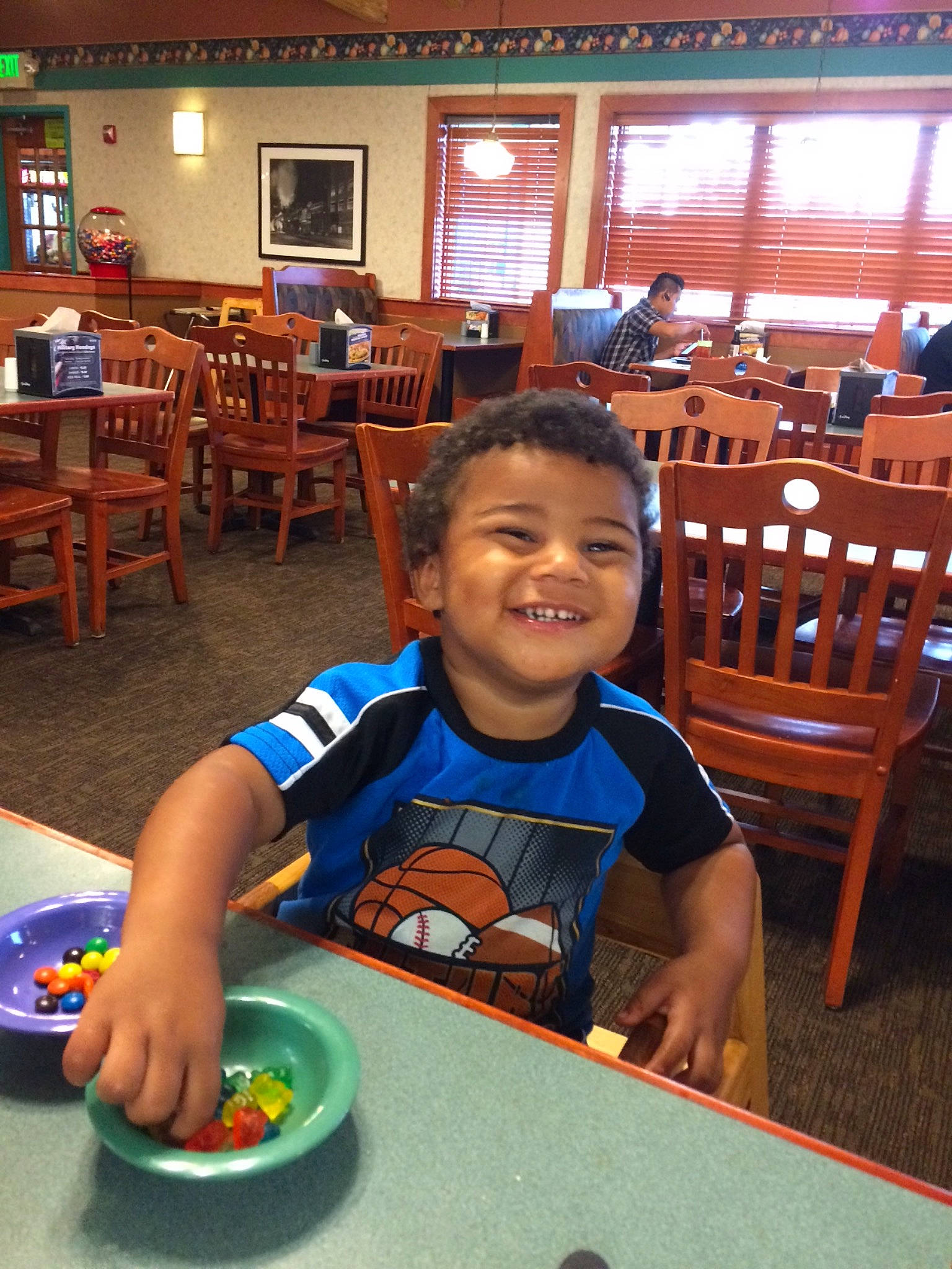 Jonathon is registered to the contest to win money with this photo: child, fun, joy, leisure, lunch, meal, person, play, restaurant, room, smile, table, toddler, vacation