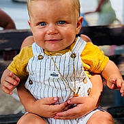 ézio participe au concours pour gagner de l'argent avec cette photo : baby, bench, blue_eyes, child, closeup, cute, hands, happy, innocent, legs, necklace, outdoor, person, portrait, skin, smiling, striped_romper, toddler, winnie_the_pooh, yellow_shirt