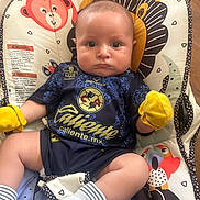 Asher joined the competition — help win amazing prizes! baby, infant, child, sportswear, mittens, socks, baby_seat, animal_print, colorful, indoor, portrait, cute, serious, clothing, footwear, fabric, comfort, young, person, sitting