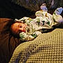 Rene joined the competition — help win amazing prizes! baby, infant, pajamas, dinosaur_print, pacifier, bed, blanket, sleepwear, child, cute, indoors, resting, soft, comfort, lying_down, person, cozy, warm_lighting, face, young