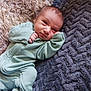 baby, infant, onesie, blanket, soft, texture, lying_down, cute, small, child, sleepwear, cozy, portrait, face, person, newborn, indoors, resting, comfort, warm