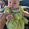 Gloria joined the competition — help win amazing prizes! baby, child, yellow_dress, headband, hand, car_interior, steering_wheel, sunlight, portrait, cute, person, holding, embroidery, window, seat, tattoo, skin, face, expression, clothing