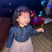 Angelina joined the competition — help win amazing prizes! toddler, child, denim_jacket, skirt, laughing, indoor, wooden_floor, toy, unicorn_toy, party_lights, smiling, happy, person, hair, flooring, furniture, home, playful, cute, celebration
