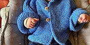 Charly participe au concours pour gagner de l'argent avec cette photo : baby, baby_seat, blue_hoodie, child, clothing, comfort, cozy, cute, face, feet, hands, indoor, infant, knitted_clothing, patterned_cushion, portrait, sitting, smiling, warm, wooden_buttons